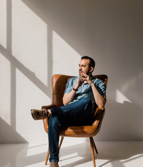 Man in a mindful pose in a bright and airy room.